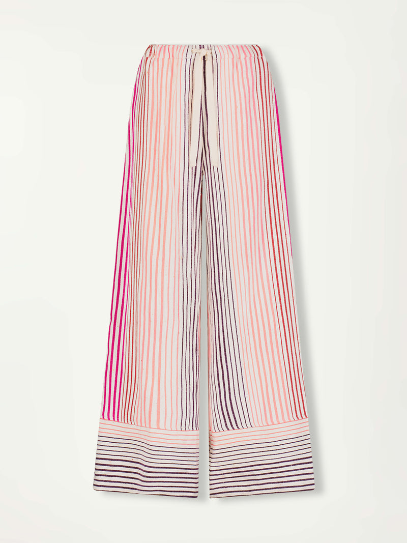 Product Front Shot of lemlem Desta Wide Leg Pants featuring ombre stripe pattern, where deep plum seamlessly transitions into peach, chestnut, and bright pink