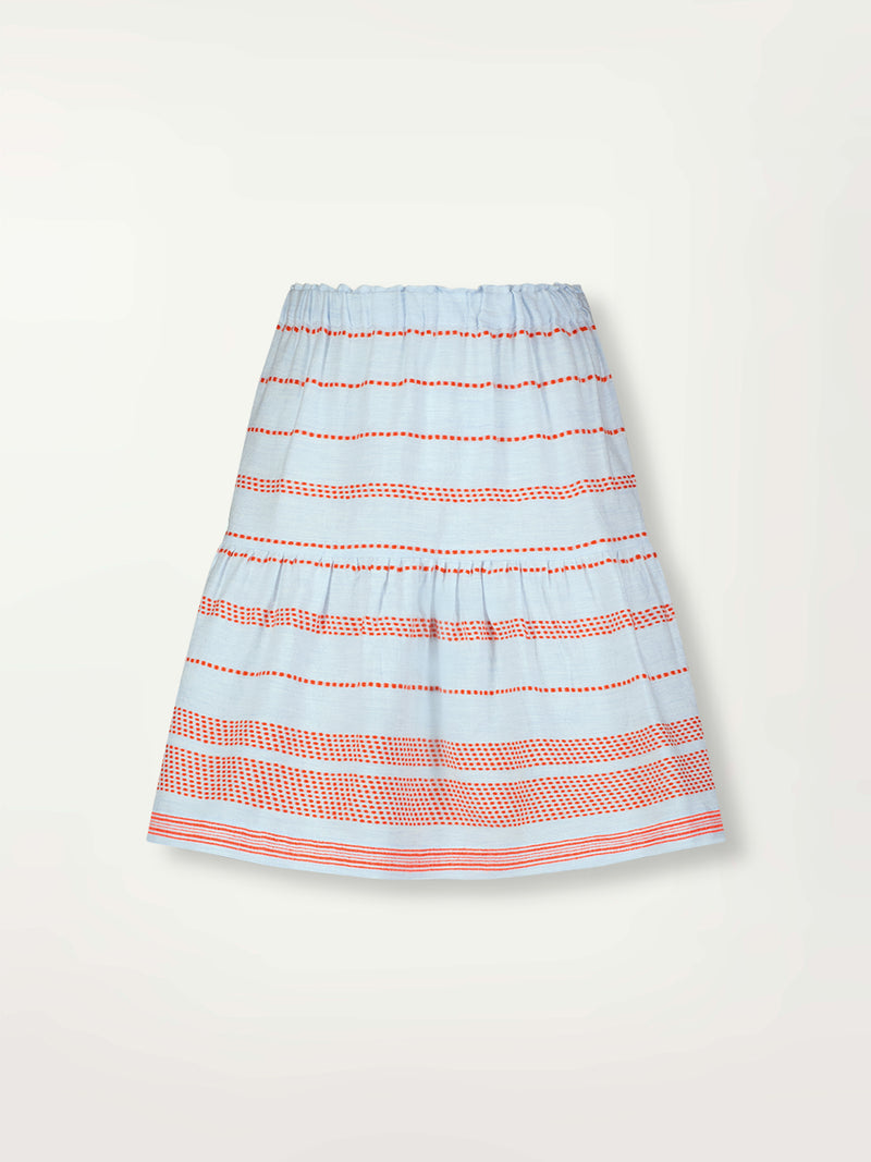 Product Front Shot of lemlem Cheri Skirt featuring playful pattern of red dots becoming stripes on a pale blue background