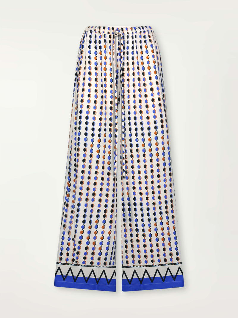 Product Front Shot of lemlem Desta Pants featuring diamond pattern in natural terracotta and rich blue hues against a cream background
