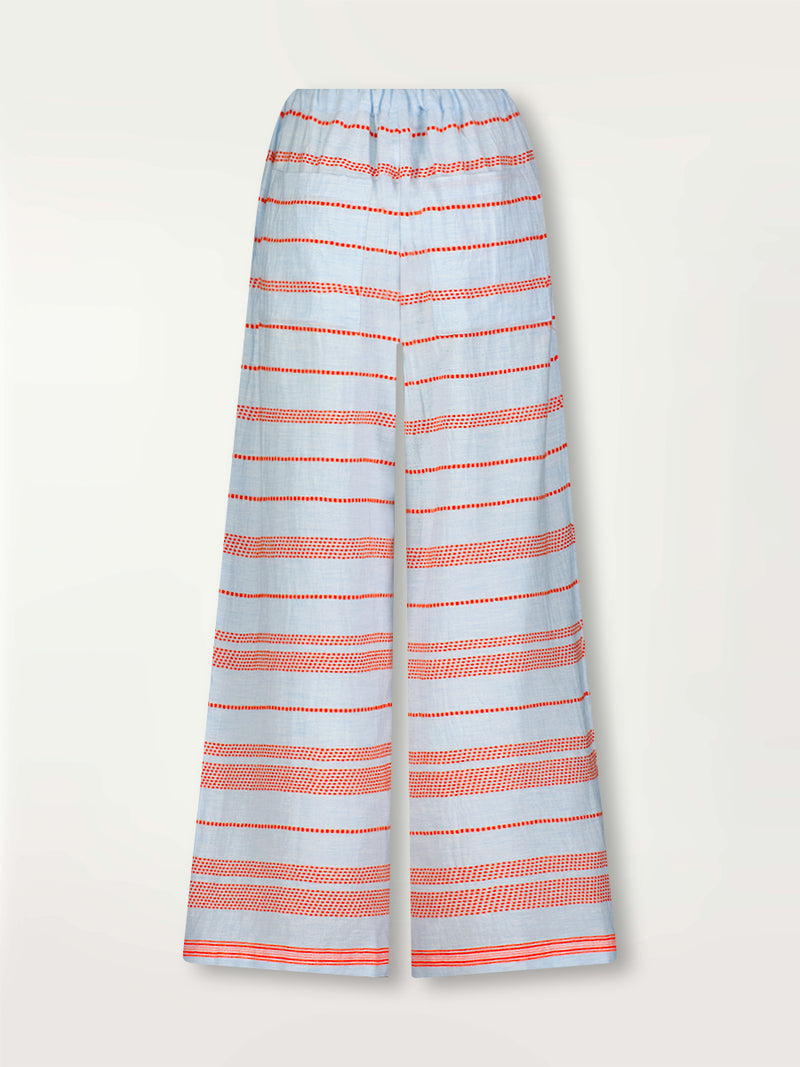 Product Back Shot of lemlem Desta Pants featuring playful pattern of red dots becoming stripes on a pale blue background