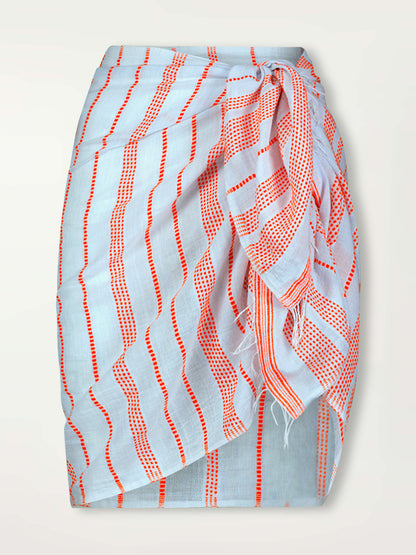 Product Front Shot of lemlem Lema Sarong featuring playful pattern of red dots becoming stripes on a pale blue background