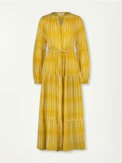 Product front shot of lemlem peasant dress featuring  vibrant yellow base adorned with a striking white Tibeb pattern. 