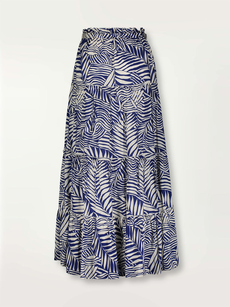 Product shot of the Palm Leaf Maxi Skirt featuring palm tree patterns on a rich blue background.