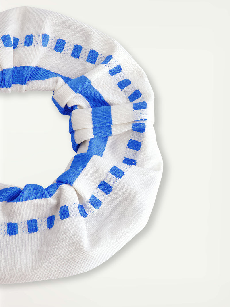 Close up on  lemlem Lishan Scrunchie Featuring crisp white background and bright blue stripes and dots pattern