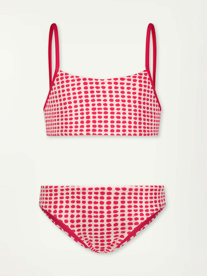 Product Front Shot of lemlem Kuleni Bikini swimsuit featuring vibrant raspberry dots on an ivory background