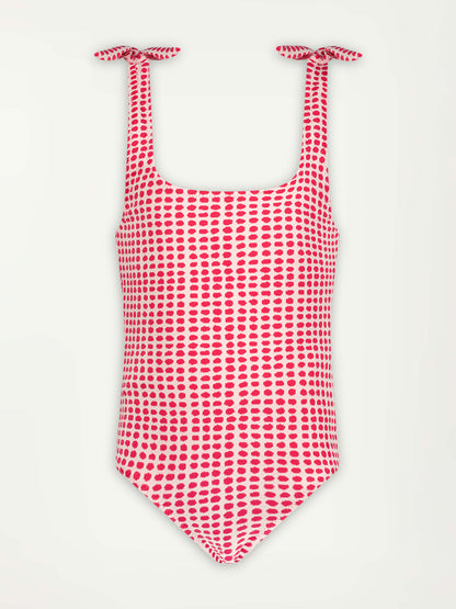 Product Shot of lemlem Sosina One Piece swimsuit featuring  vibrant raspberry dots on an ivory background