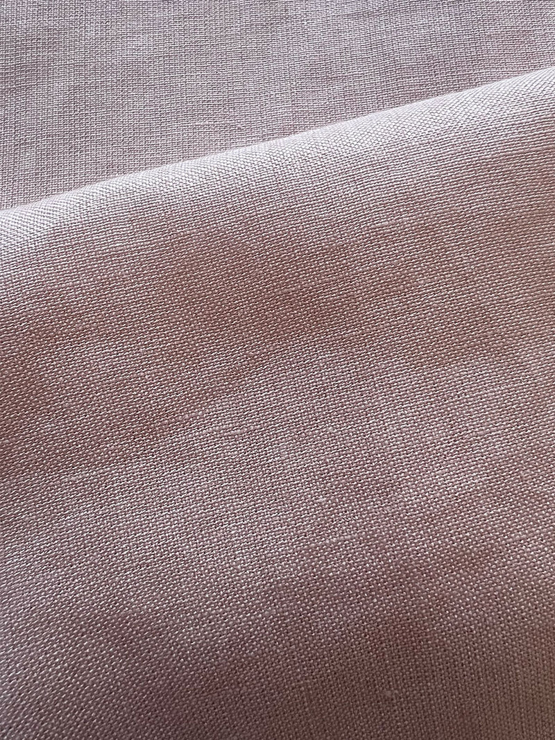 close up on lemlem koki pink fabric featuring pale peach linen blend