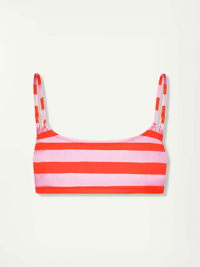 Woman Standing Wearing lemlem ASHA Scoop Top  featuring  bold and vibrant neon orange red, accented by soft rose stripe