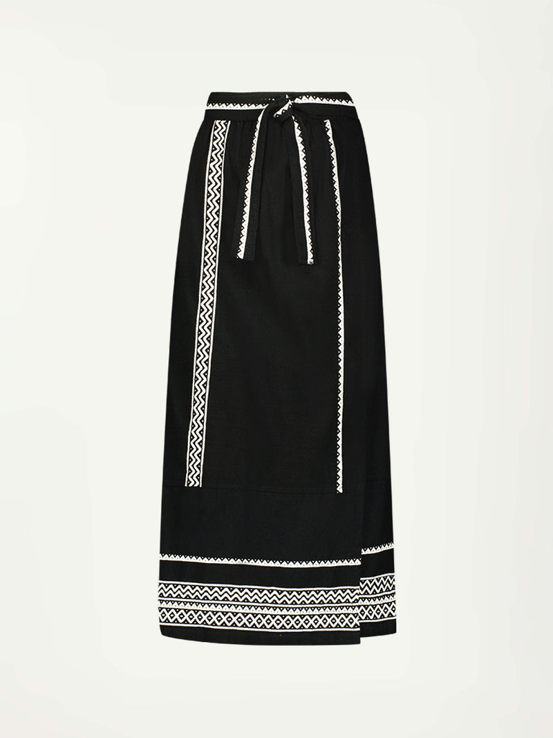 Product Front Shot of  lemlem TOLA Skirt Featuring rich black background with intricate cream Tibeb border pattern 