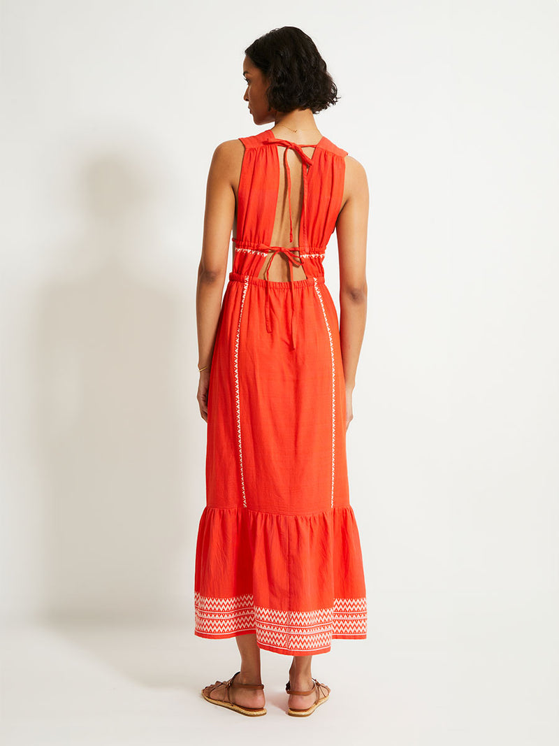 Back of a Woman Standing Wearing lemlem LELISA Dress featuring an intricate Tibeb pattern in rich red and vanilla colors