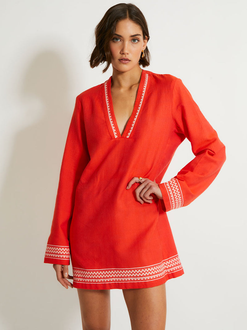 Woman Standing Wearing lemlem Raey Dress featuring an intricate Tibeb pattern in rich red and vanilla colors