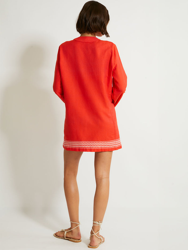 Woman's Back Standing Wearing lemlem Raey Dress featuring an intricate Tibeb pattern in rich red and vanilla colors