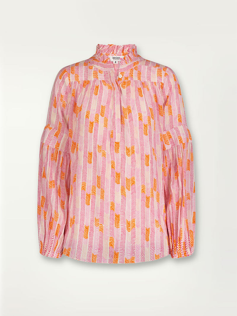 Front product shot of the Gigi Ruffle Blouse in Multi Pink featuring pink, peach and orange allover chevron print and strips of gold lurex.